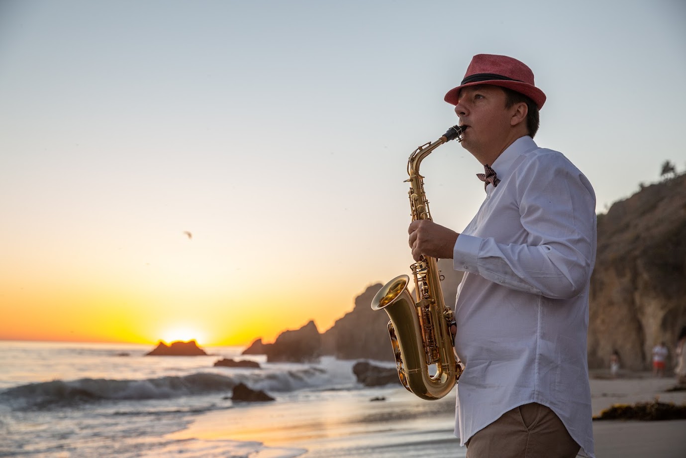 Saxophonist plays sax on the beach